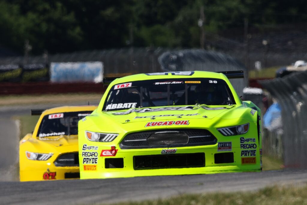 Front end shot of two yellow Trans Am TA2 Mustangs